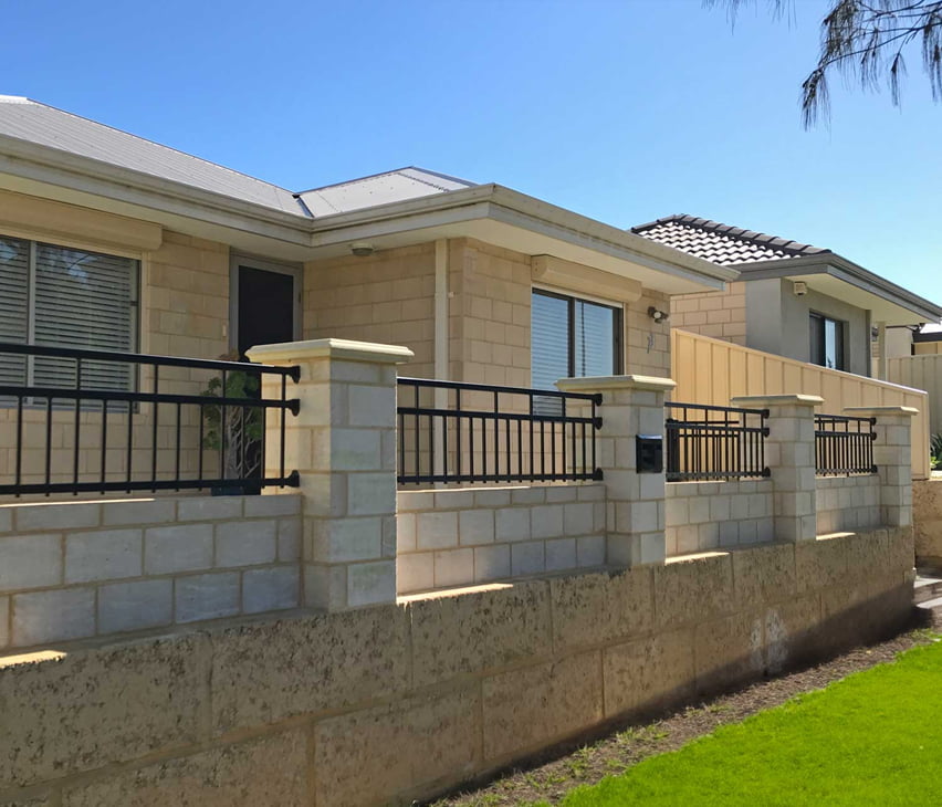 black stylish fencing on limestone wall